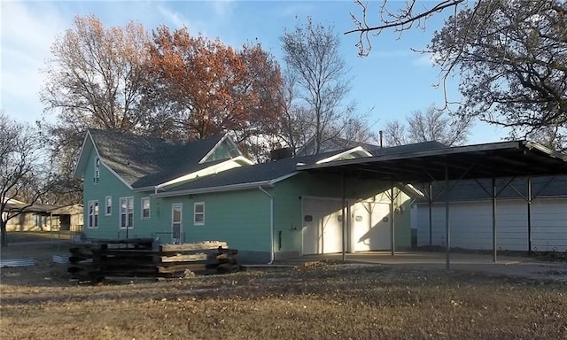 back of property featuring a carport