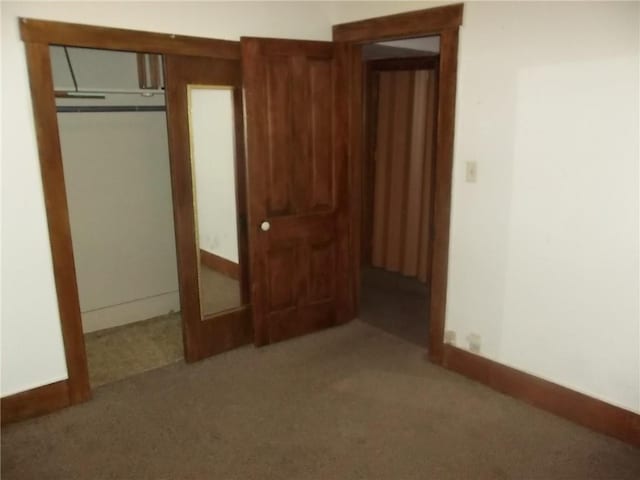 unfurnished bedroom featuring a closet and carpet floors