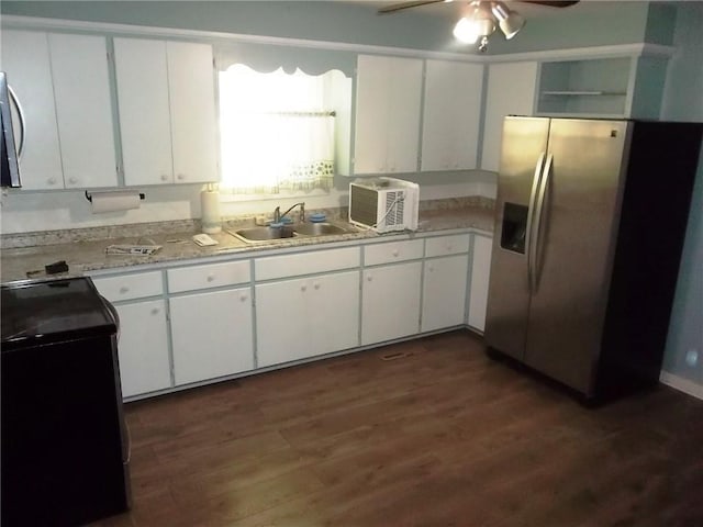 kitchen with white cabinets, dark hardwood / wood-style floors, sink, and stainless steel appliances