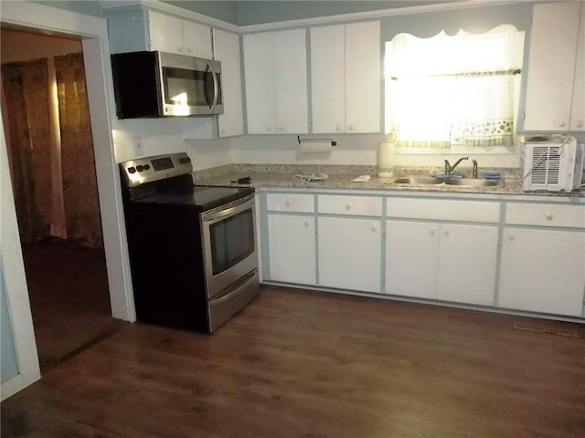 kitchen with white cabinets, appliances with stainless steel finishes, dark wood-type flooring, and sink