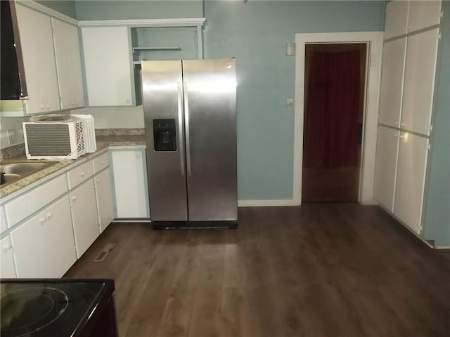 kitchen featuring dark wood-type flooring, white cabinets, sink, black electric range, and stainless steel fridge