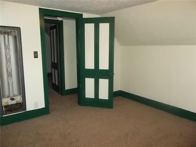 bonus room featuring carpet flooring and vaulted ceiling