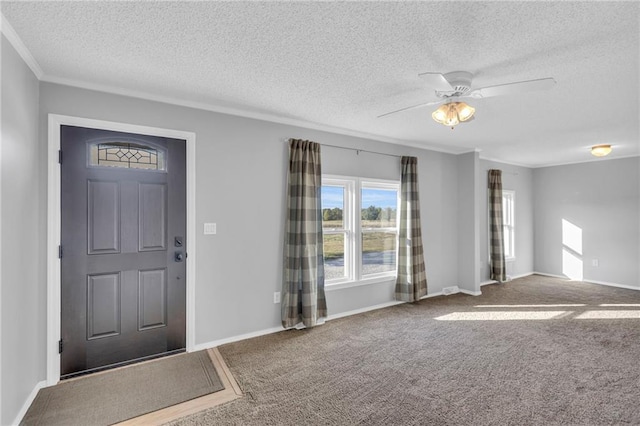 carpeted entrance foyer featuring a textured ceiling and ceiling fan