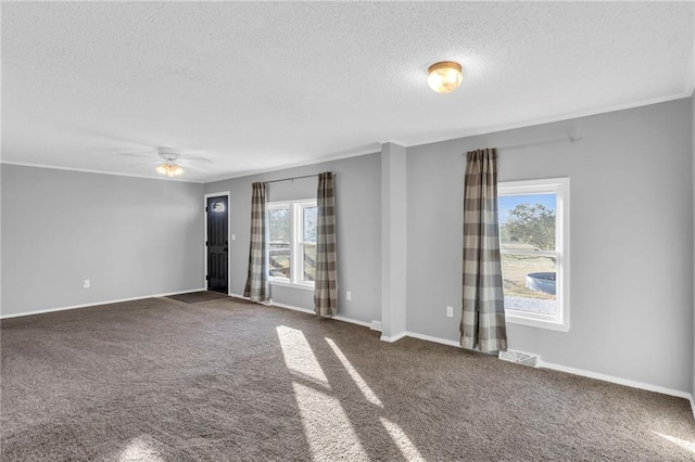 carpeted empty room with a textured ceiling, ceiling fan, and crown molding