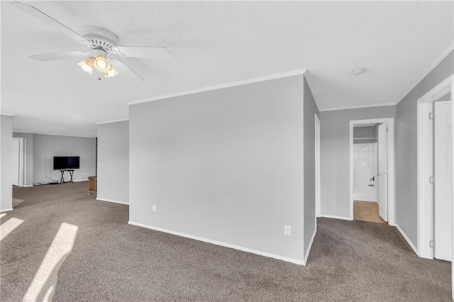 unfurnished living room with carpet flooring, a textured ceiling, ceiling fan, and ornamental molding