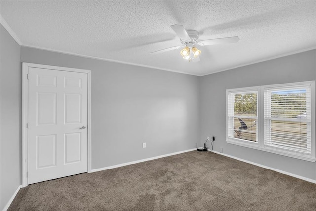 empty room with carpet flooring, ceiling fan, and a textured ceiling