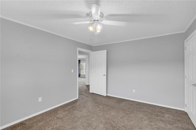 carpeted empty room with ceiling fan, a textured ceiling, and ornamental molding