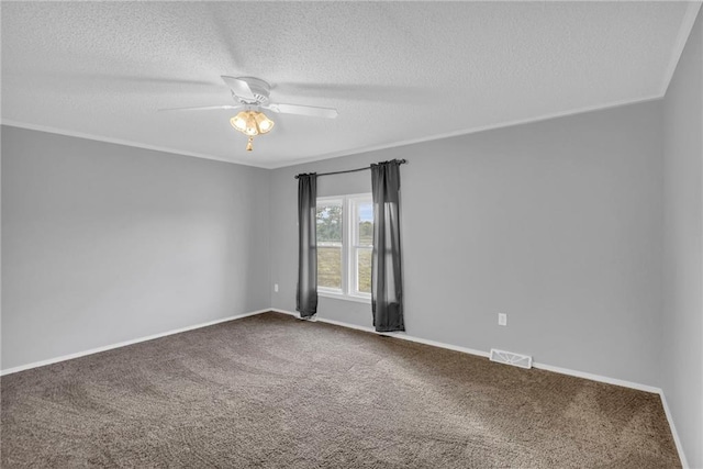 carpeted empty room with ceiling fan and a textured ceiling