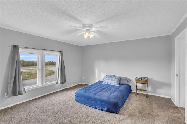 bedroom with carpet, ceiling fan, ornamental molding, and a textured ceiling