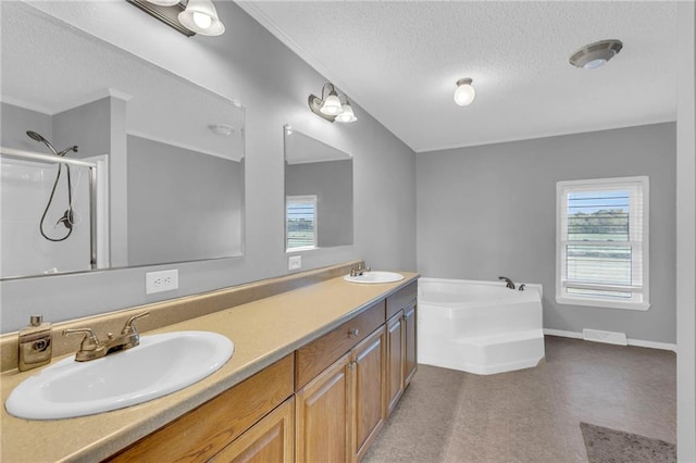 bathroom with vanity, a textured ceiling, and plus walk in shower