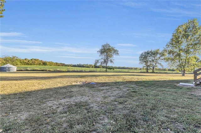 view of yard with a rural view