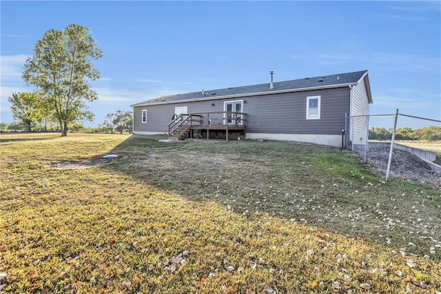 back of house featuring a yard and a deck