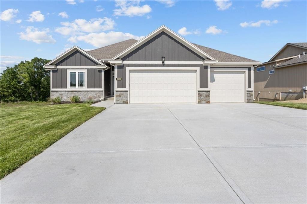 view of front of home with a front lawn and a garage