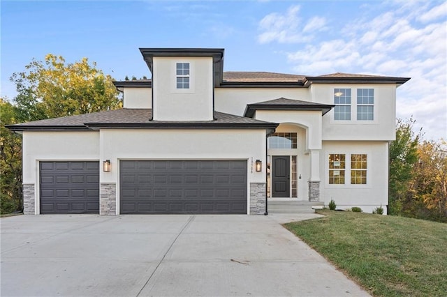 view of front of property with a front lawn and a garage