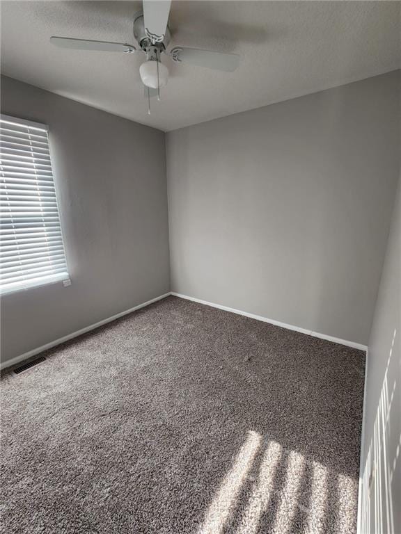 empty room featuring ceiling fan and carpet floors