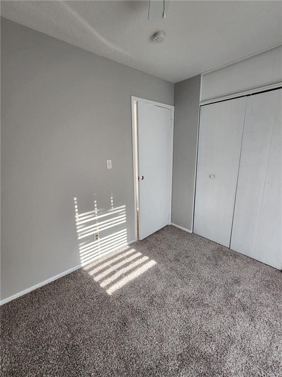 unfurnished bedroom with carpet flooring and a closet