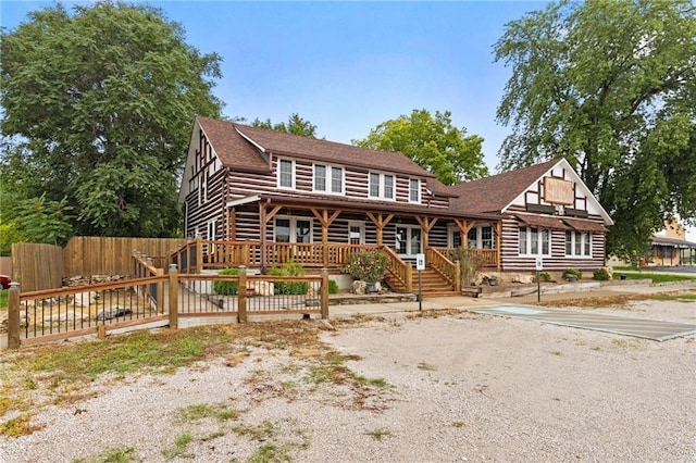 121 W US Highway 40, Odessa, MO 64076 - cabin with log exterior, roof with shingles, and a wooden deck