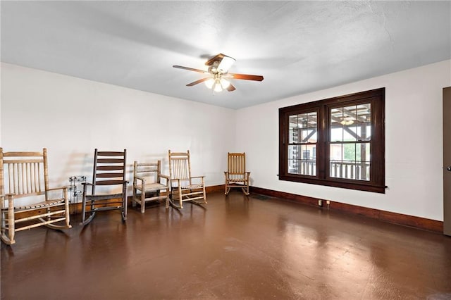 121 W US Highway 40, Odessa, MO 64076 - living area featuring a ceiling fan and finished concrete floors