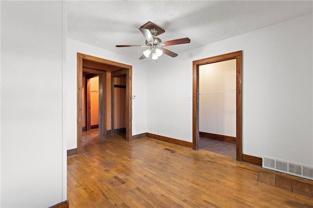 unfurnished bedroom featuring dark hardwood / wood-style floors and ceiling fan