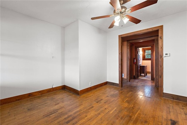 unfurnished room with ceiling fan and dark hardwood / wood-style floors