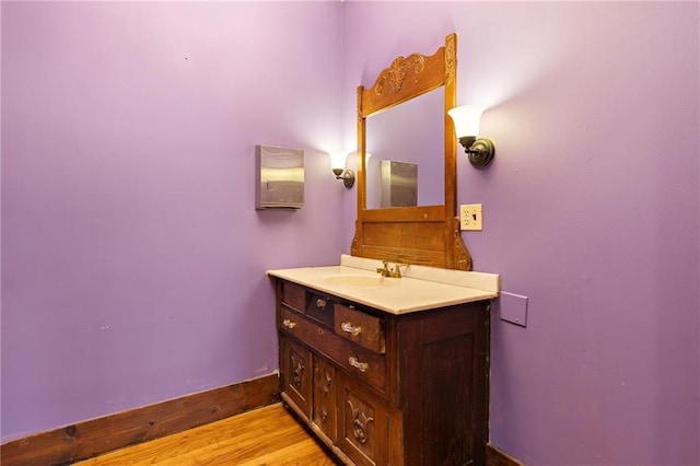 bathroom with vanity and hardwood / wood-style flooring