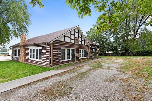 121 W US Highway 40, Odessa, MO 64076 - view of property exterior featuring a chimney, a yard, and log exterior