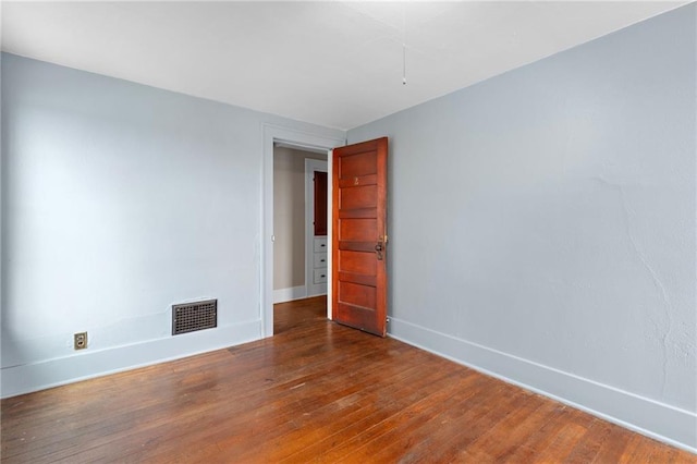 empty room with dark hardwood / wood-style floors