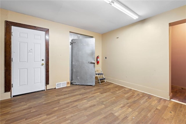 unfurnished room with hardwood / wood-style floors