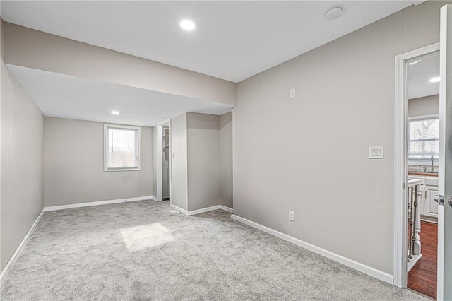 basement featuring light colored carpet