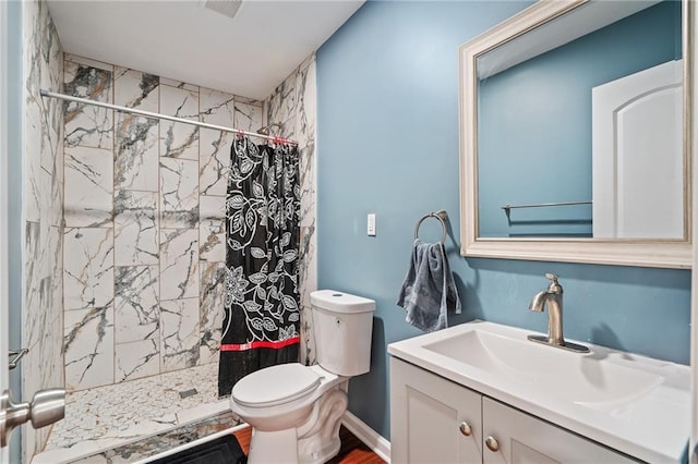 bathroom featuring vanity, toilet, and curtained shower