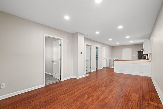 unfurnished living room with hardwood / wood-style flooring