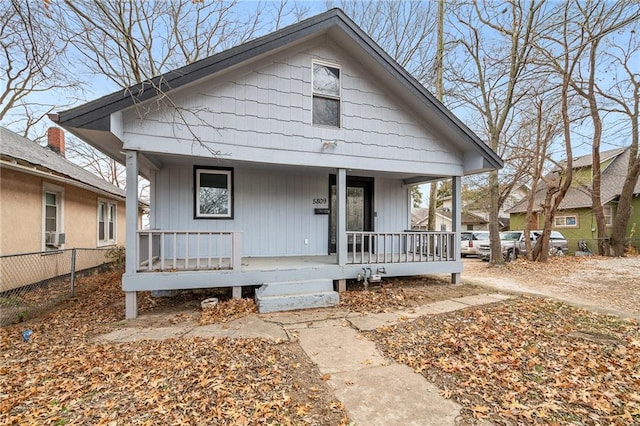 bungalow-style home featuring fence and a porch