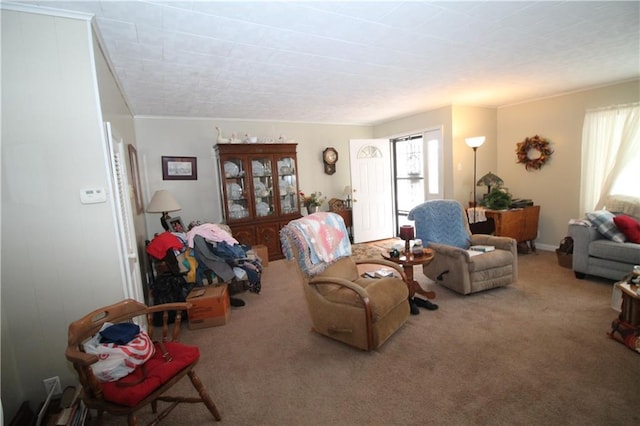 living room featuring carpet floors, a healthy amount of sunlight, and ornamental molding