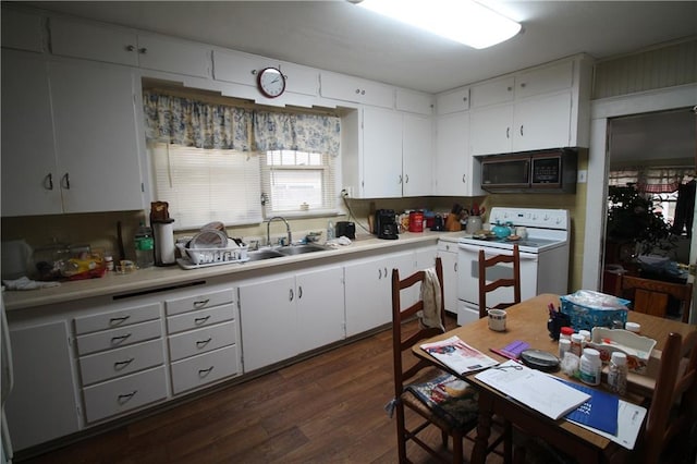 kitchen featuring white cabinets, dark hardwood / wood-style floors, white electric stove, and sink