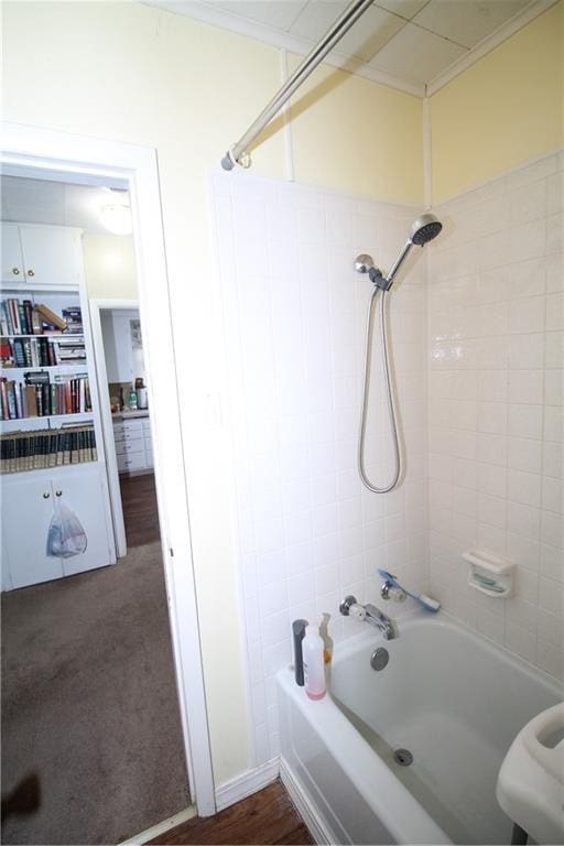 bathroom with bathtub / shower combination and ornamental molding