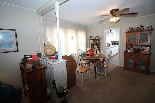 dining room featuring dark colored carpet and crown molding