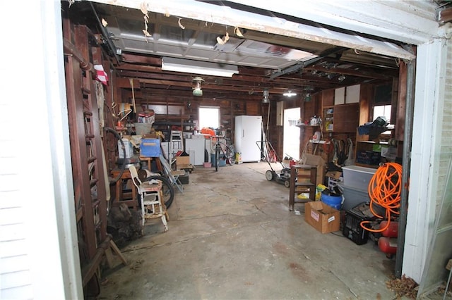 garage with white refrigerator and independent washer and dryer