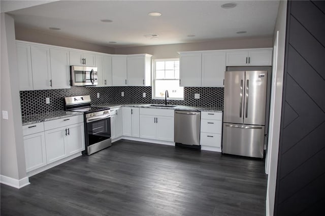 kitchen featuring white cabinetry, stainless steel appliances, dark wood-type flooring, and sink