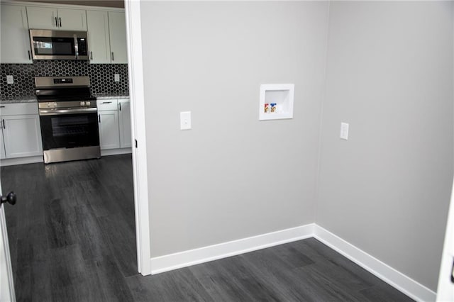 kitchen featuring backsplash, dark wood-type flooring, and stainless steel appliances