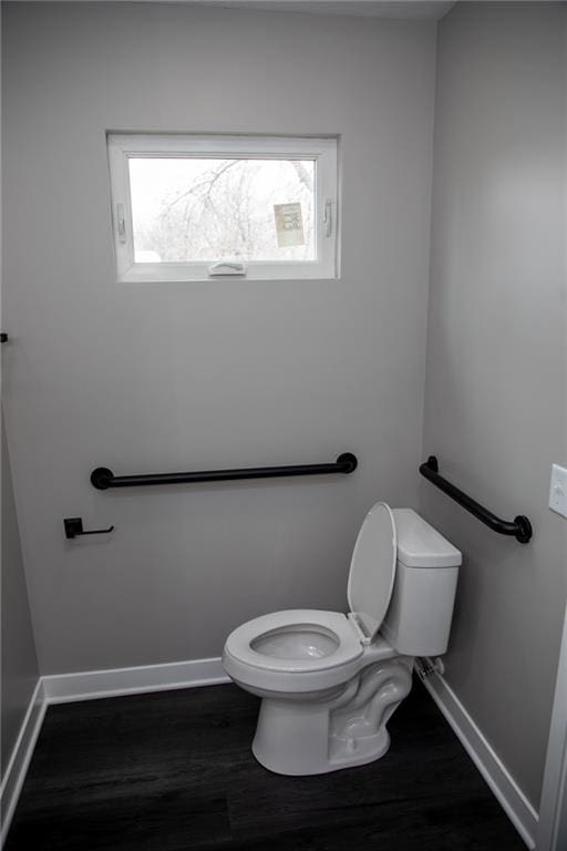 bathroom featuring hardwood / wood-style flooring and toilet