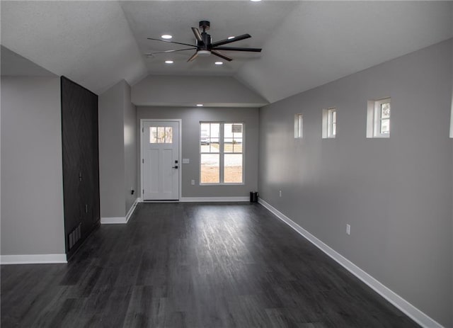 entryway with dark wood-type flooring, ceiling fan, and lofted ceiling