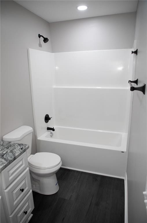 full bathroom featuring hardwood / wood-style flooring, vanity, toilet, and shower / bathing tub combination