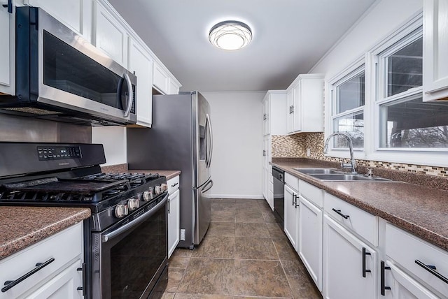 kitchen featuring sink, backsplash, white cabinetry, and black appliances