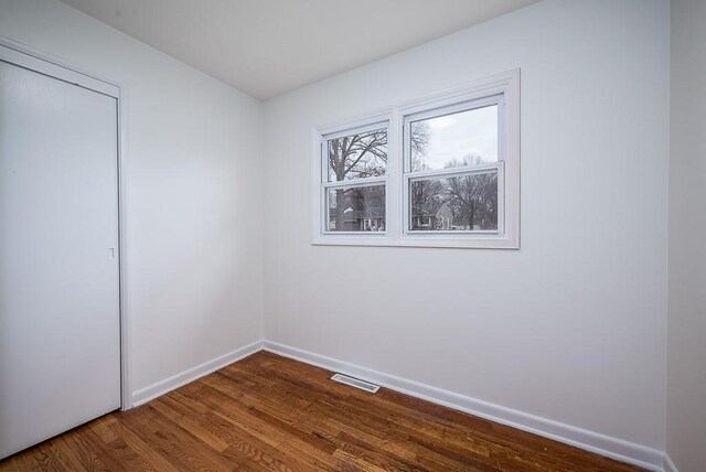 unfurnished bedroom featuring hardwood / wood-style floors and a closet