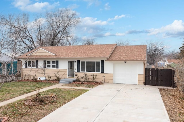 ranch-style house featuring a front yard and a garage