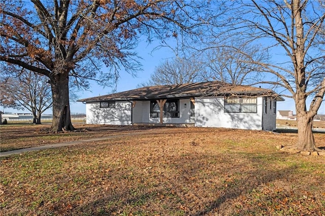 ranch-style house with a front lawn