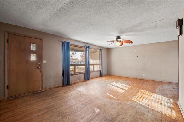 interior space with ceiling fan, hardwood / wood-style floors, and a textured ceiling