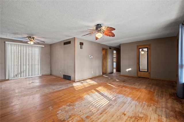 unfurnished living room with ceiling fan, a textured ceiling, and light wood-type flooring