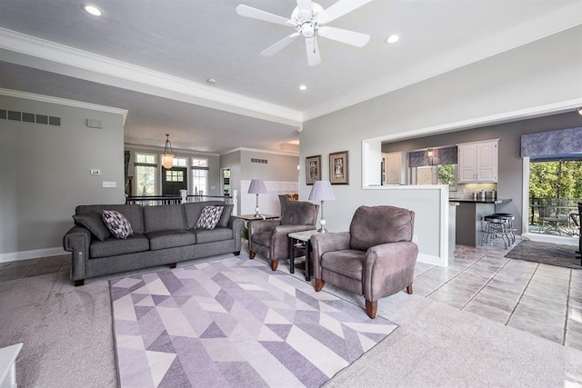 tiled living room featuring ceiling fan and crown molding