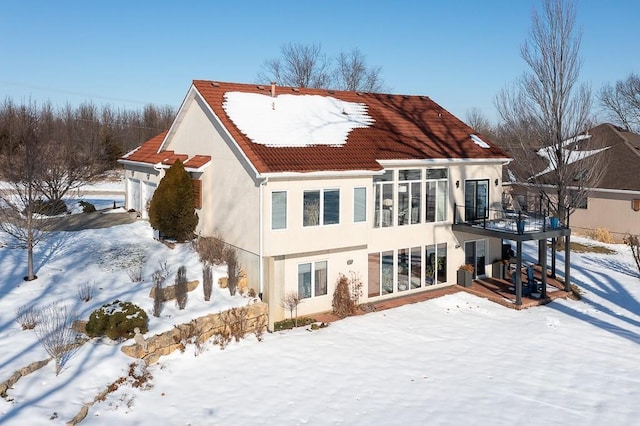 snow covered house with a balcony